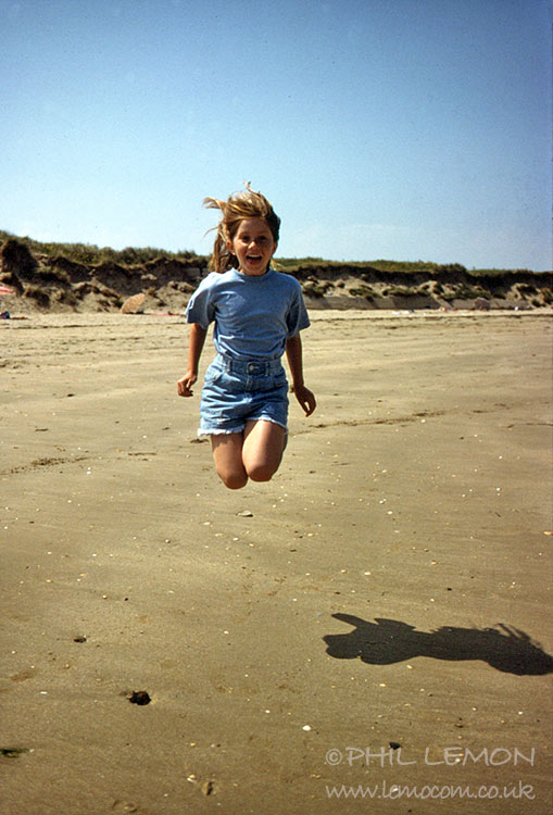 Child jumping on the beach, Phil Lemon